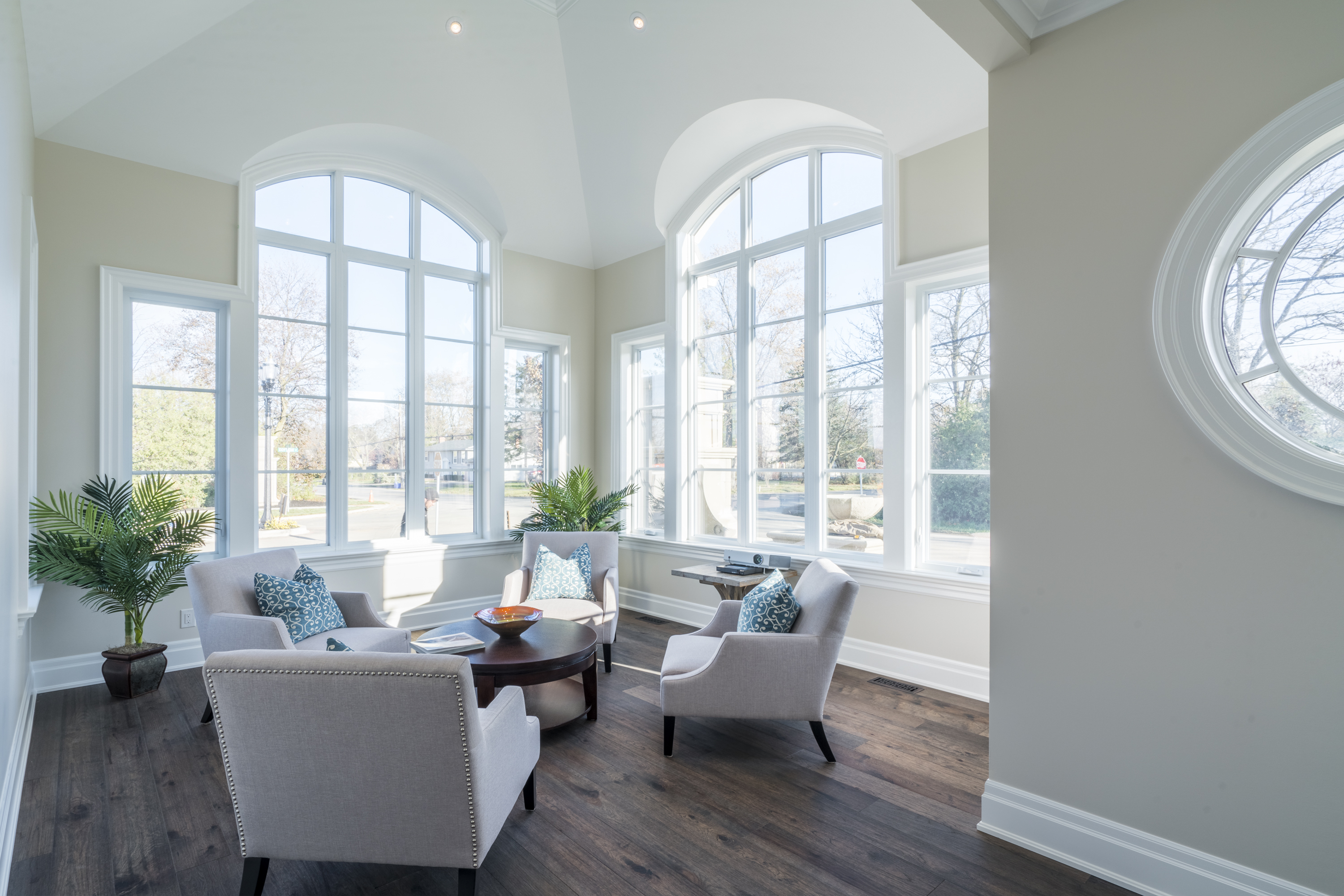 Sun filtering in through casement and fixed windows to illuminate a living room