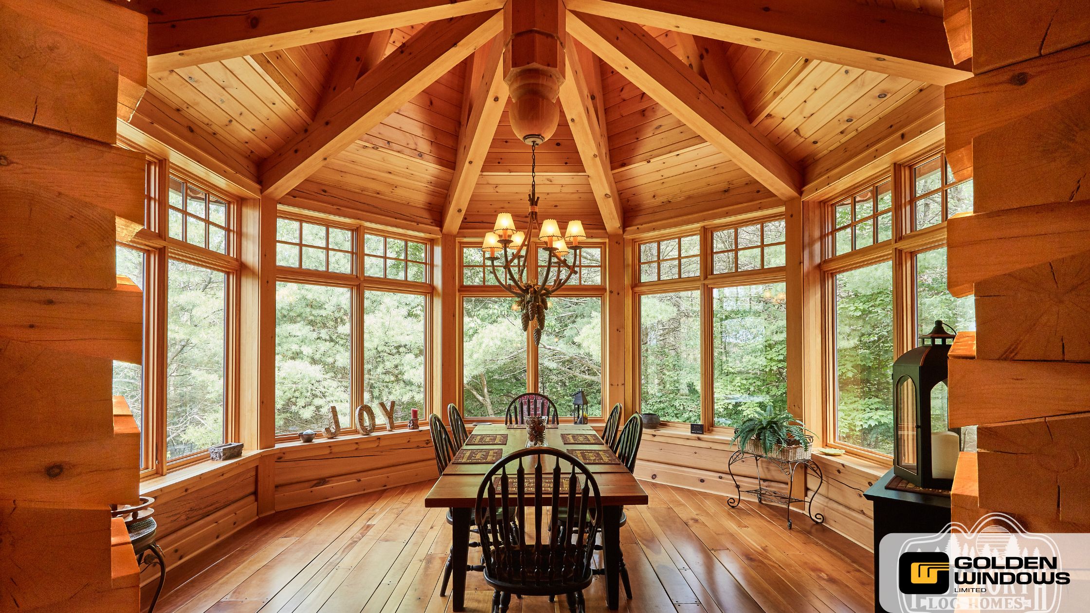 Rustic wood dining room surrounded by bay windows, highlighting Golden Windows’ craftsmanship and the natural beauty of custom wood-framed window designs.